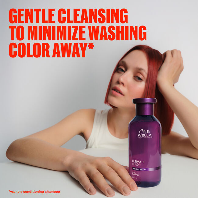 Wella Ultimate Color Shampoo bottle beside a model with vivid red hair - gentle cleansing to minimize washing color away