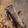 A tube of Oway Silk’N Glow Hair Mask | Nourishing Hair Mask for Dry, Frizzy Hair lies on a stone surface with dried grass and sunlight, ideal for taming dry, frizzy hair with organic Cupuaçu butter.