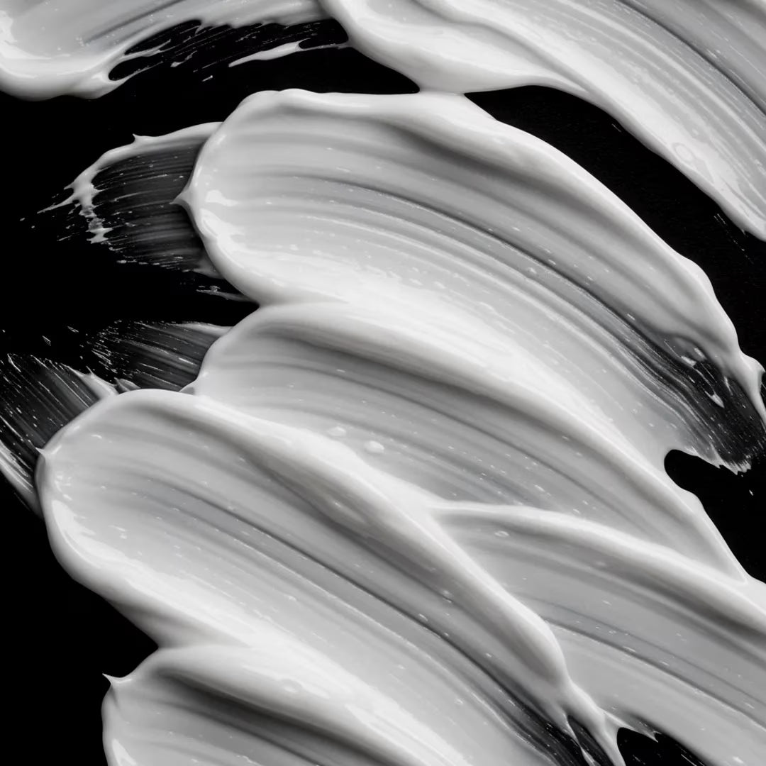 Close-up of black and white Sebastian Volupt Conditioner on a textured surface