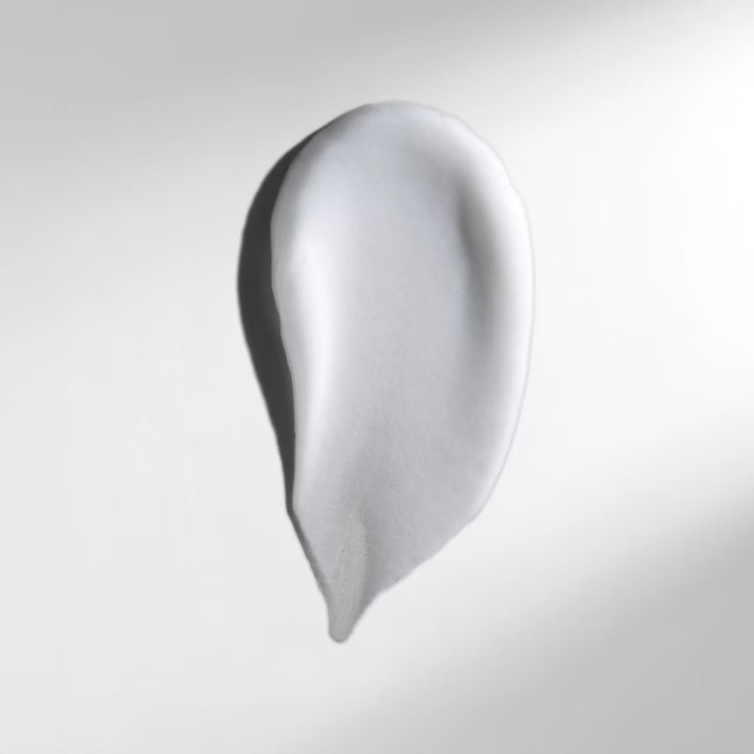 White cream smear on a light gray background