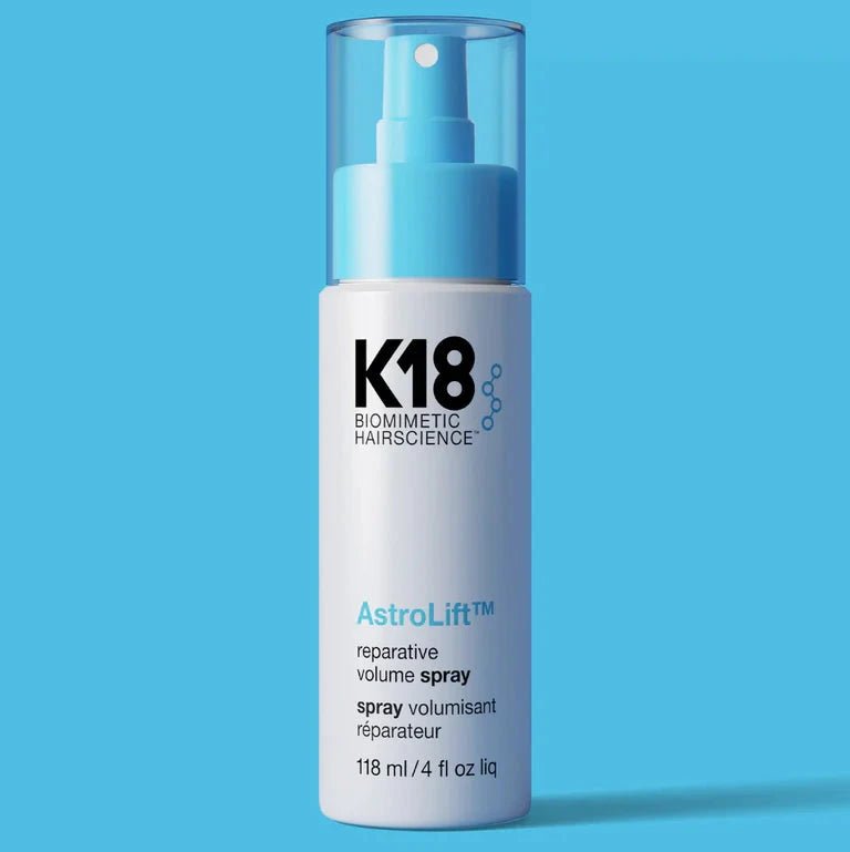 K18 AstroLift hair spray bottle on a blue background