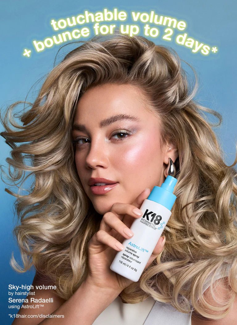 Woman holding a K18 hair product with text about hair volume and bounce on a blue background