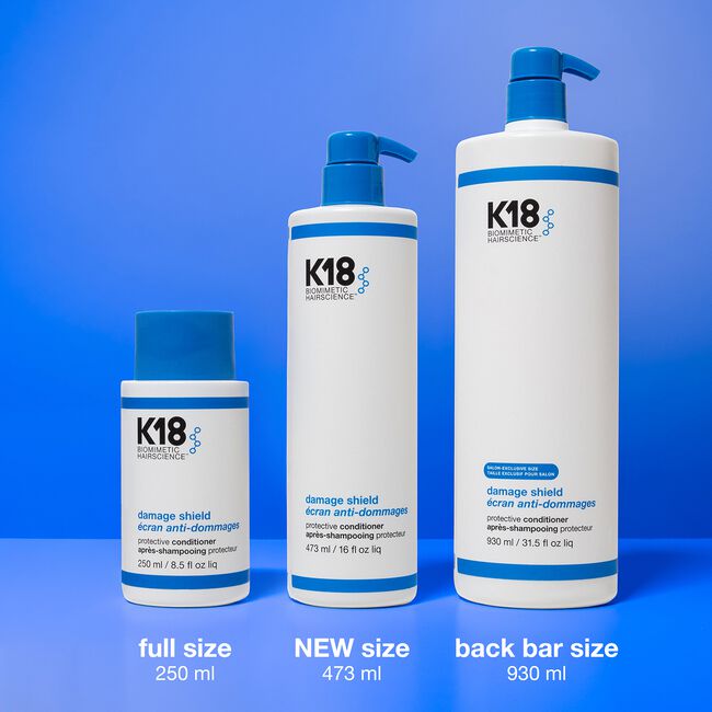 K18 hair care product bottles of different sizes on a blue background