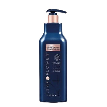 A dark blue bottle of Leaf and Flower Damage Correction Conditioner with pump dispenser, copper accents, and front label, featuring a plant-based formula, set against a light beige background. Multiple sizes available.