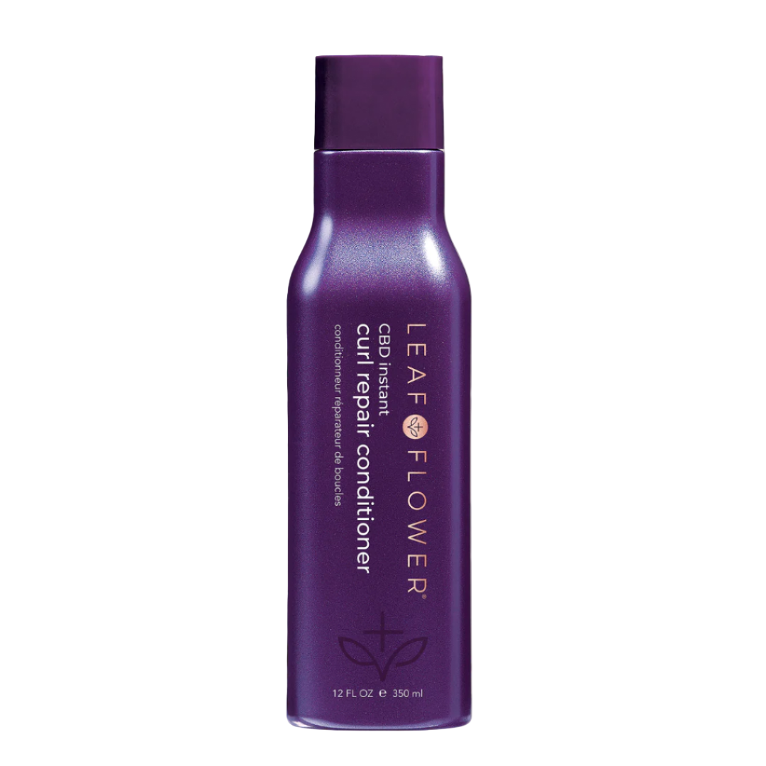 A 12 fl oz bottle of Leaf and Flower Instant Curl Repair Conditioner stands upright on a light beige background. The label features gold text with a small symbol, highlighting intense hydration and reduced frizz. Multiple sizes available.