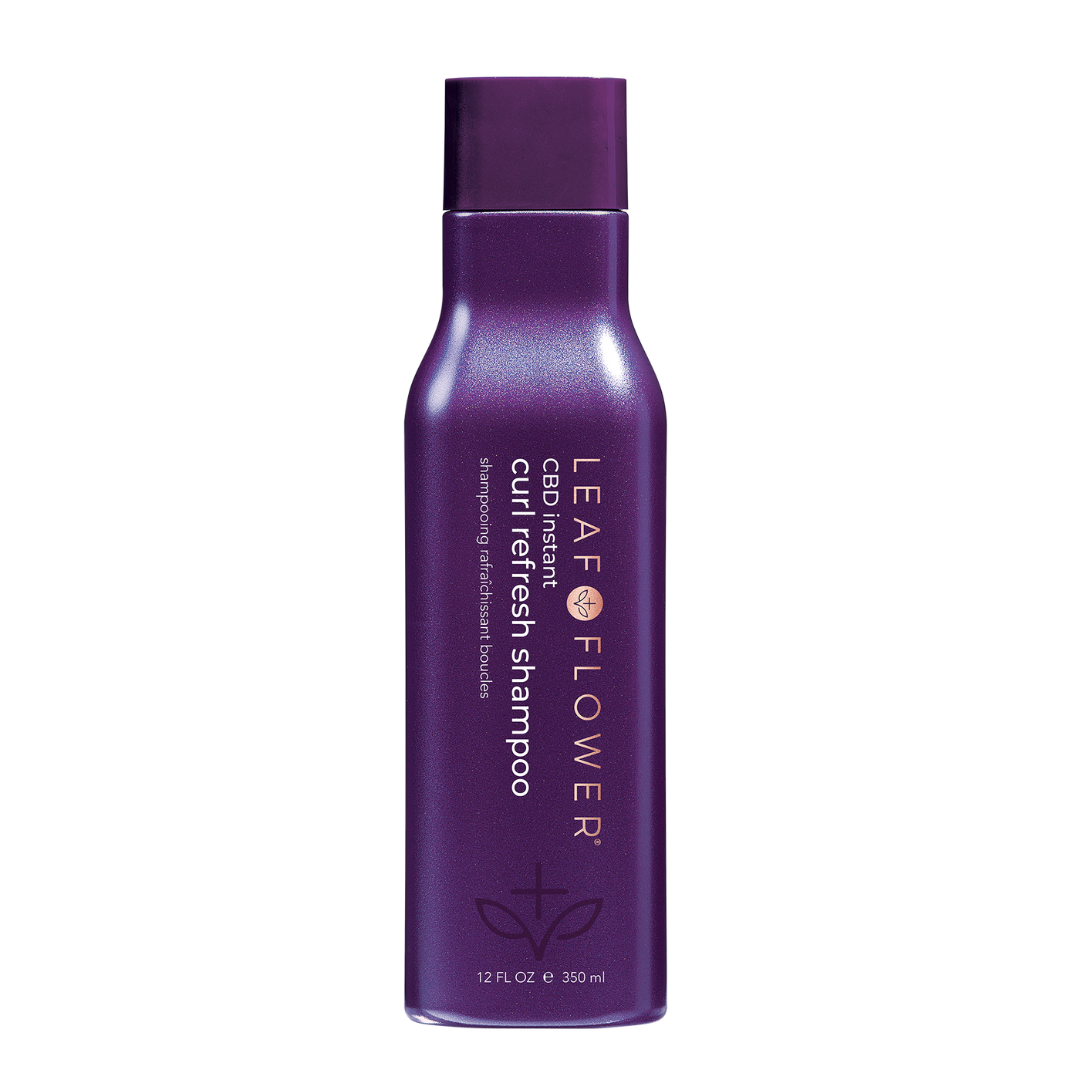 A bottle of Leaf and Flower Instant Curl Refresh Shampoo with a purple bottle.