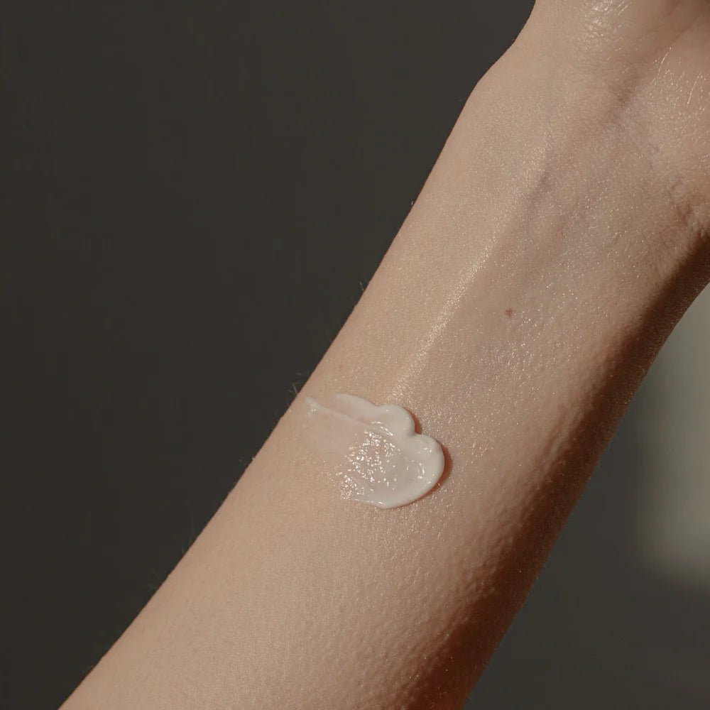 A close-up of a forearm with Oway After Sun Body Balm applied to sun-exposed skin. The plain background and soft lighting highlight the balm’s texture, emphasizing the soothing, hydrating care from Oway.