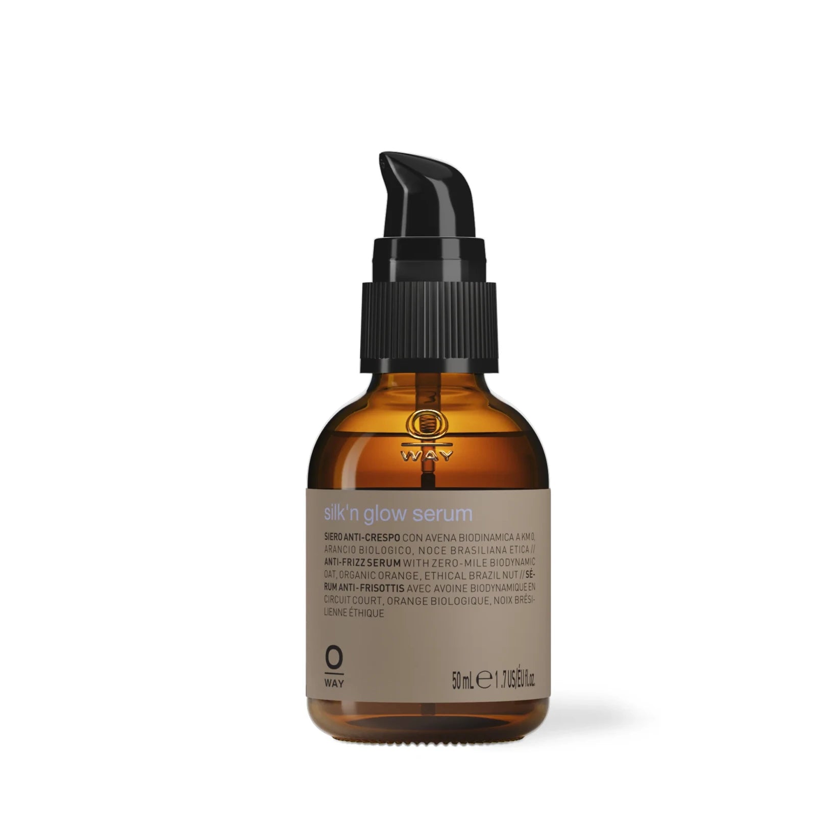 A brown glass bottle with a black pump labeled “Oway Silk’N Glow Serum | Anti-Frizz Shine Serum for Dry, Frizzy Hair” holds 50 ml (1.69 fl oz) and features product information and ingredients on the label.