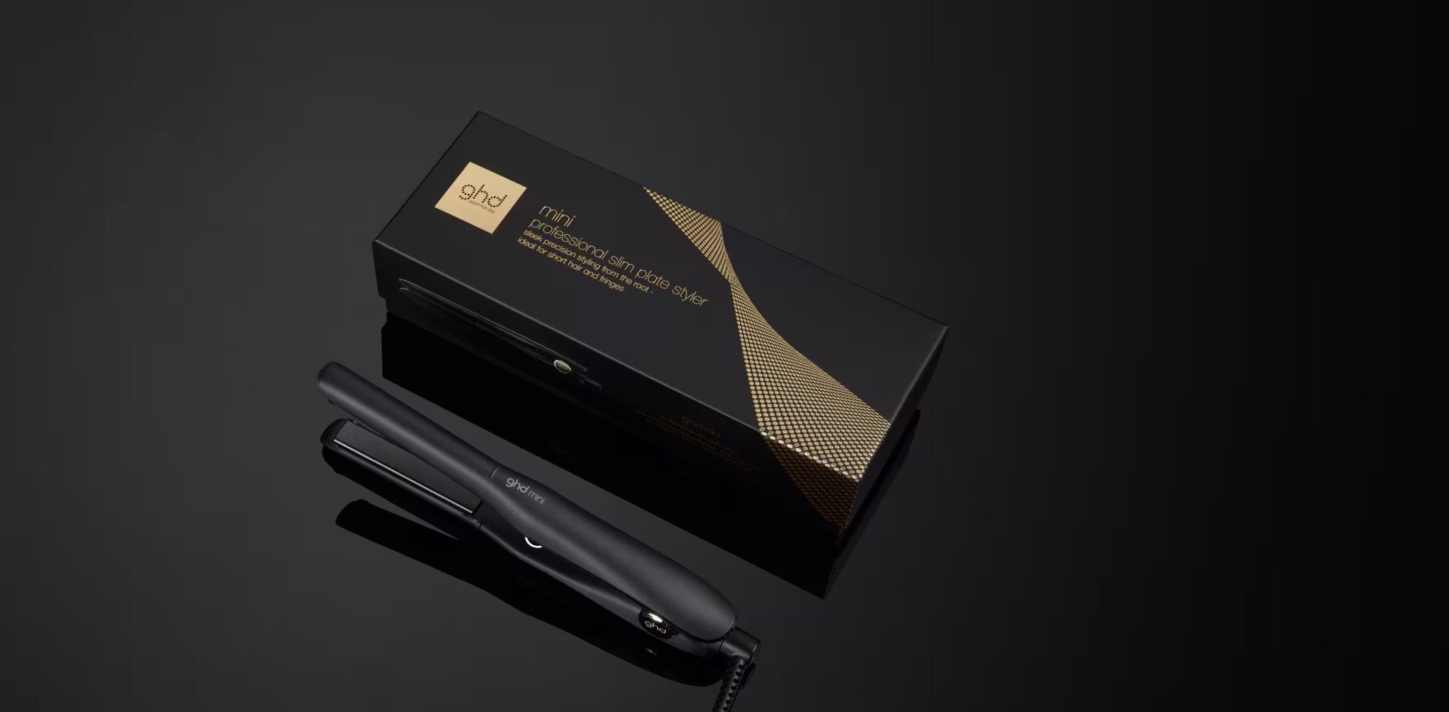 Black hair straightener with packaging on a dark background