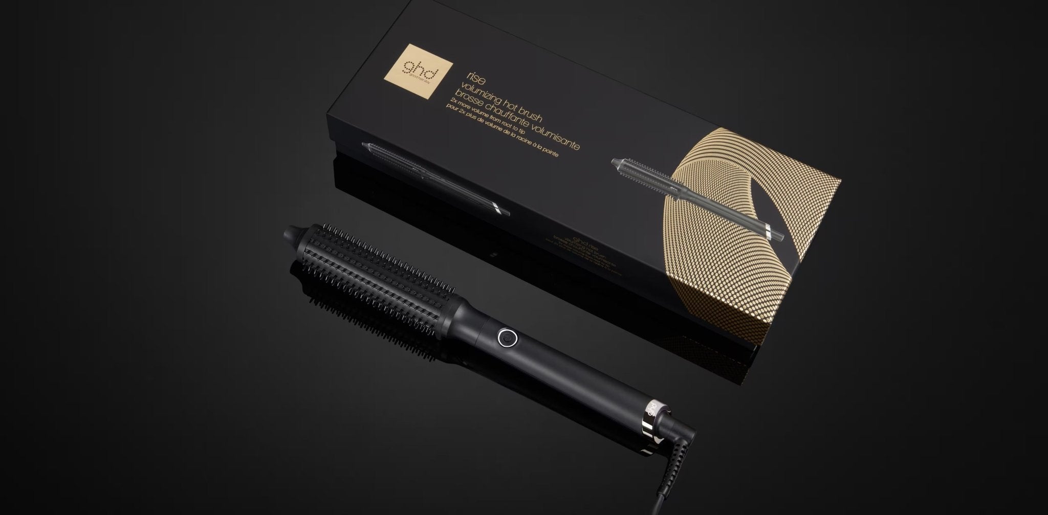 Black hair straightener with gold packaging on a black background