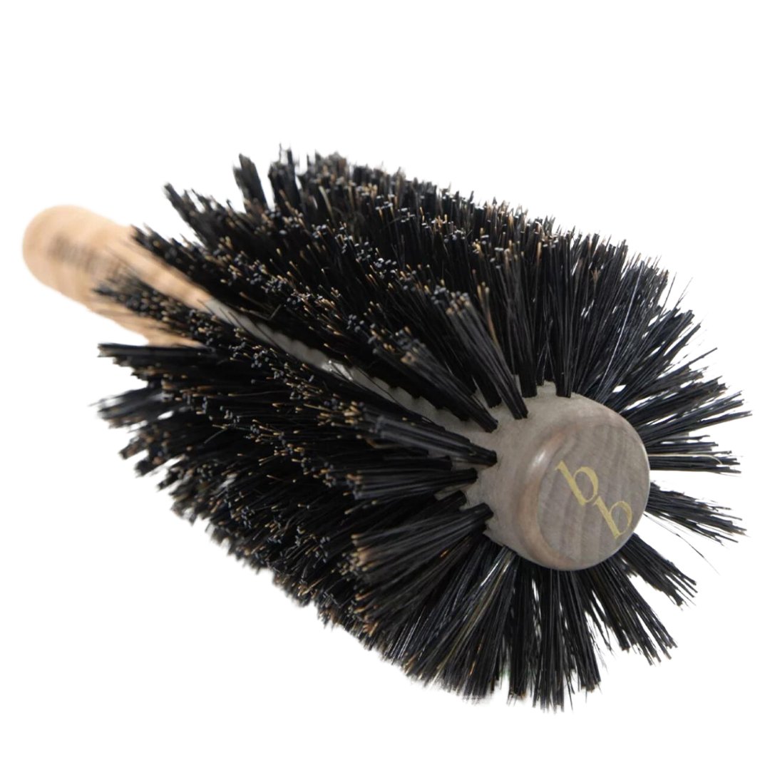 A Brazilian Blowout Boar Bristle Hair Brush with a wooden handle.