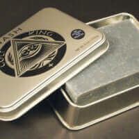 A silver tin with a Cult and King WASH | Hair Shampoo, Face Bar, Body Bar, Shave Bar | All in One bar in it.