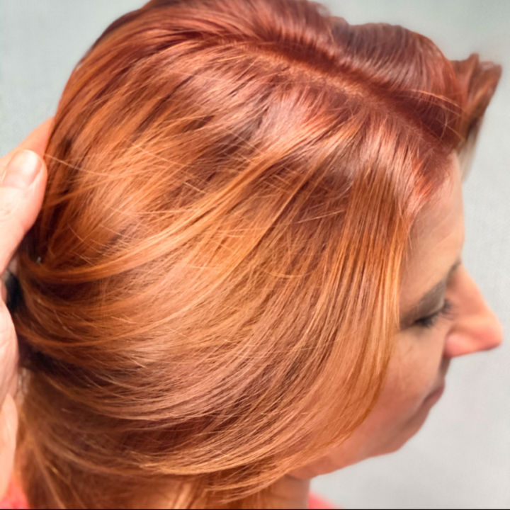 Vivid copper sunset hair color close-up