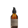 An Oway Smoothing Fluid bottle labeled "Sleek Styling Serum for Smooth, Frizz-Free Hair" stands upright against a plain black background, offering frizz control and radiant shine.