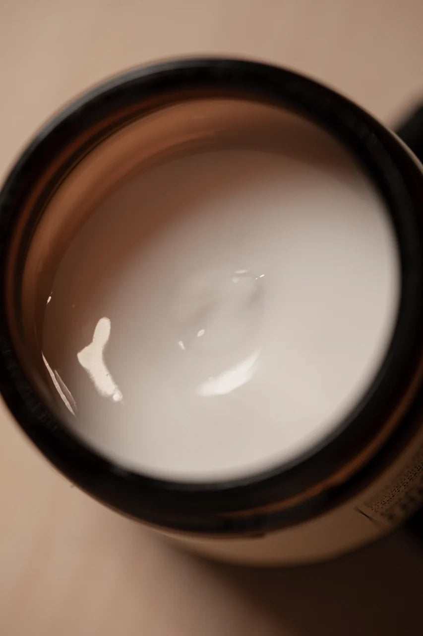 An open jar of Oway Boho Pomade | Texturizing Cream Pomade reveals a smooth, matte paste inside—ideal for flexible hold and effortless, laid-back hair styling by Oway.