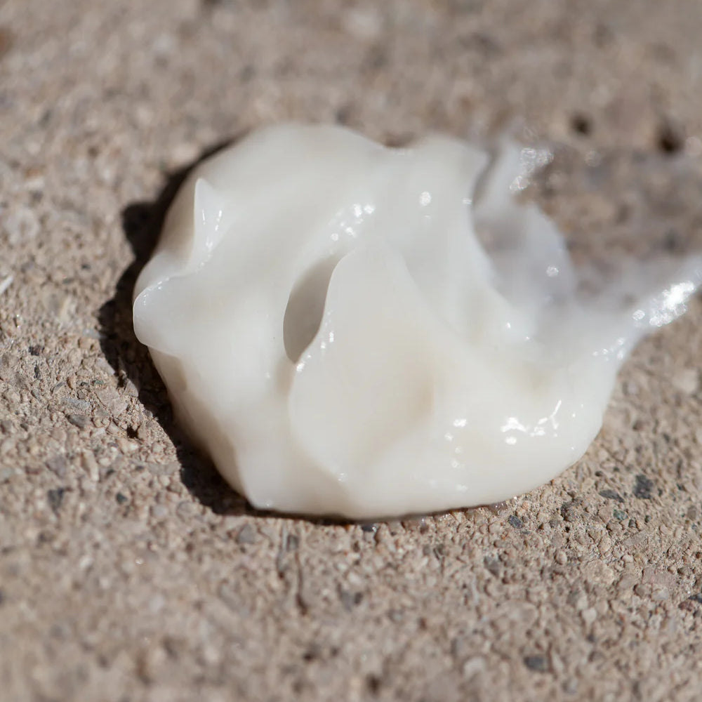 A dollop of Oway Moisturizing Hair Mask, a deep hydration mask for dry hair, is spread on a rough, textured surface.