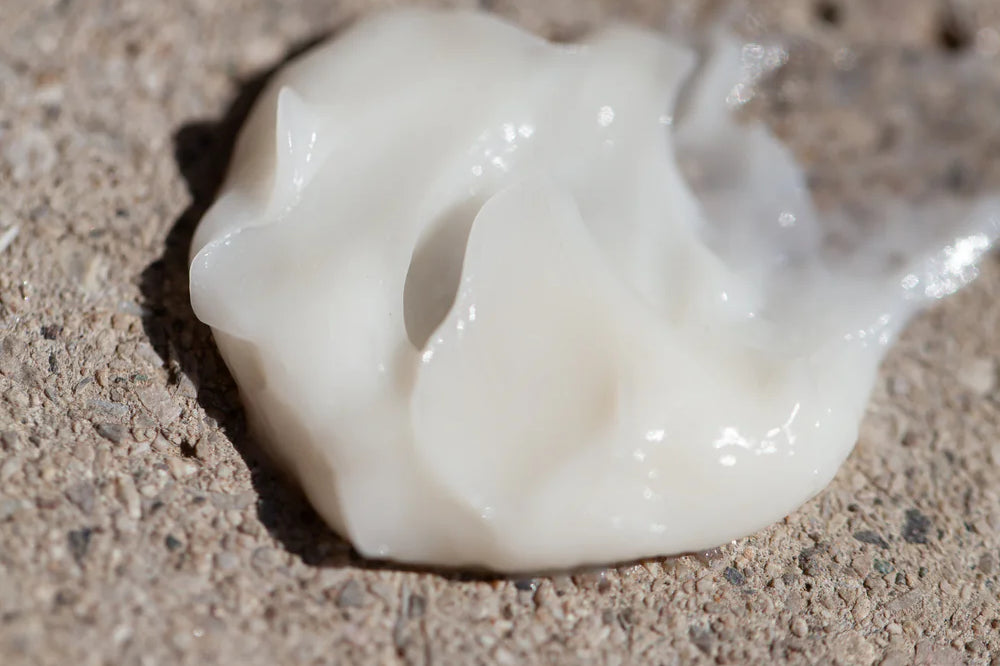 A dollop of Oway Moisturizing Hair Mask, a deep hydration mask for dry hair, is spread on a rough, textured surface.