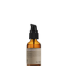 A brown glass dropper bottle with a black pump, labeled "Oway Silk’N Glow Serum | Anti-Frizz Shine Serum for Dry, Frizzy Hair," stands upright against a black background.
