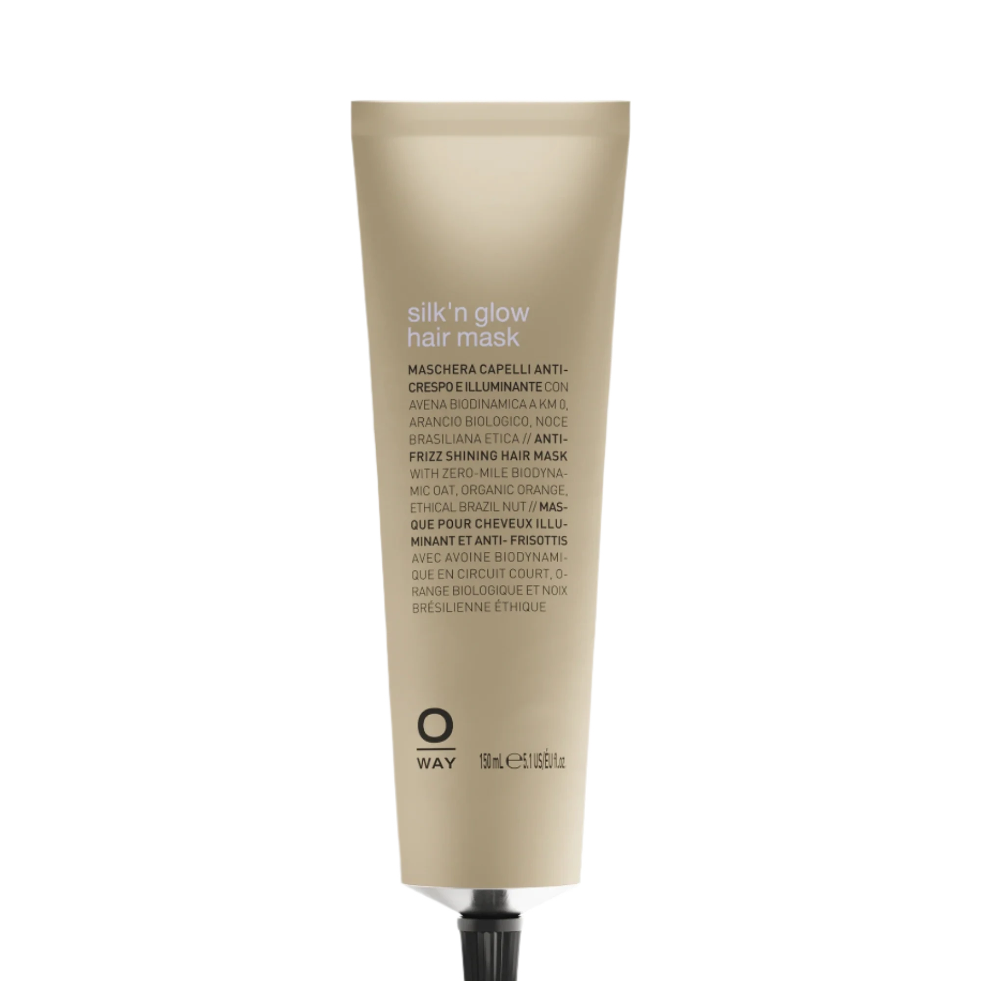 A beige tube of Oway Silk’N Glow Hair Mask for dry, frizzy hair with a black cap is displayed against a dark textured background. The label features product details in various languages.