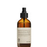 The Oway Flowerfall Aromatherapeutic Scalp and Mind Balancing Mist comes in an amber glass spray bottle with a black nozzle and beige label, offering holistic scalp care using Biodynamic Lavender.