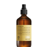 Amber spray bottle of Oway Molding Mist | Humidity-Resistant Spray for Shape and Memory with black pump, displayed against a textured black background, offers frizz protection.
