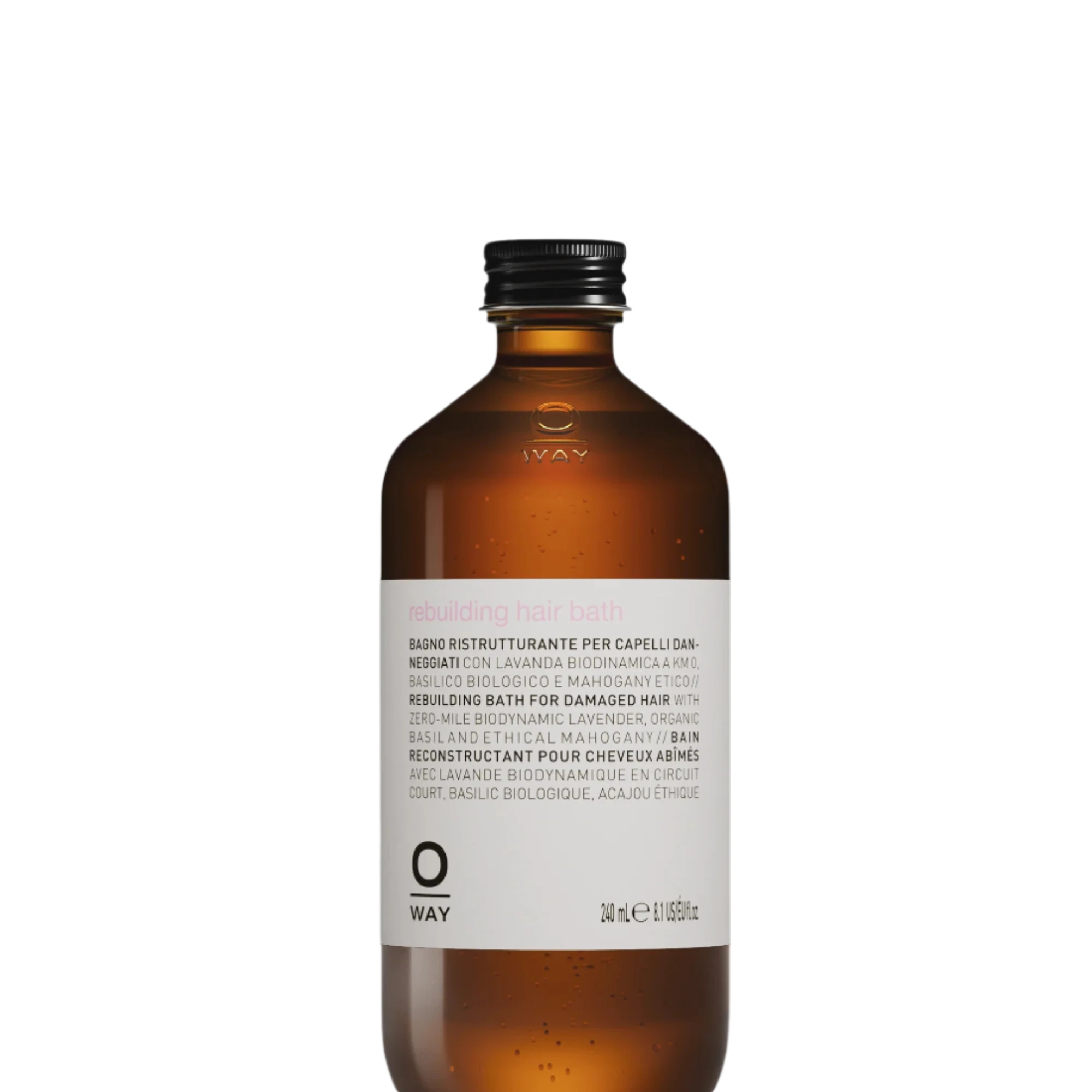 A 240ml brown glass bottle labeled “Oway Rebuilding Hair Bath | Strengthening Shampoo for Brittle, Weak Hair” by Oway features a black screw cap and plant-derived keratin to strengthen damaged hair.