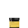 A small amber jar with a black lid labeled “Oway Boho Pomade” rests on a dark textured surface, offering a laid-back, matte finish with flexible hold.