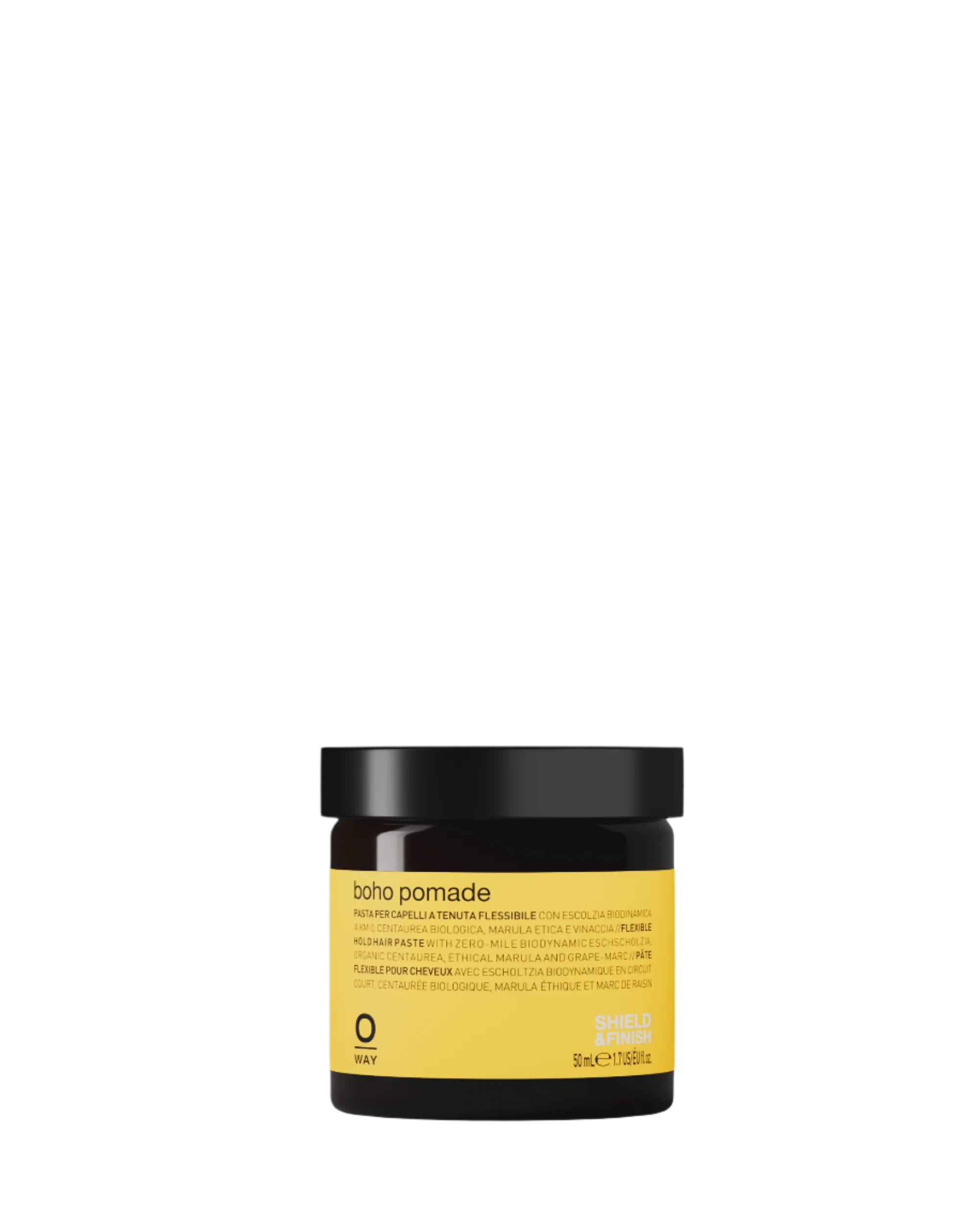 A small amber jar with a black lid labeled “Oway Boho Pomade” rests on a dark textured surface, offering a laid-back, matte finish with flexible hold.
