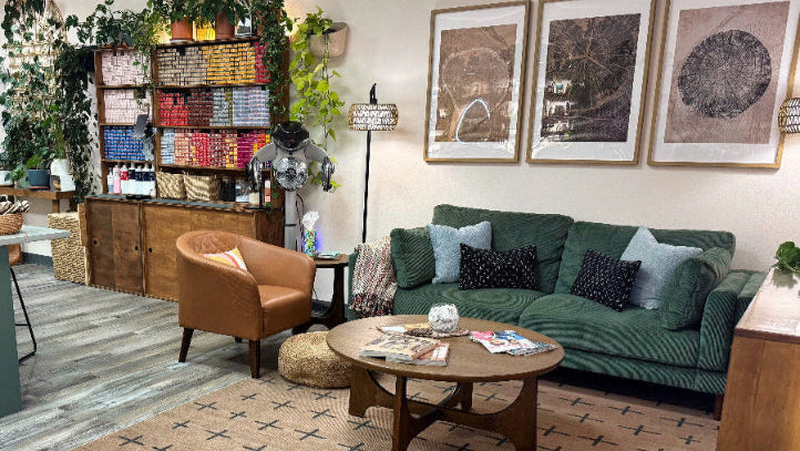 Living room with a green sofa, coffee table, and decorative items.