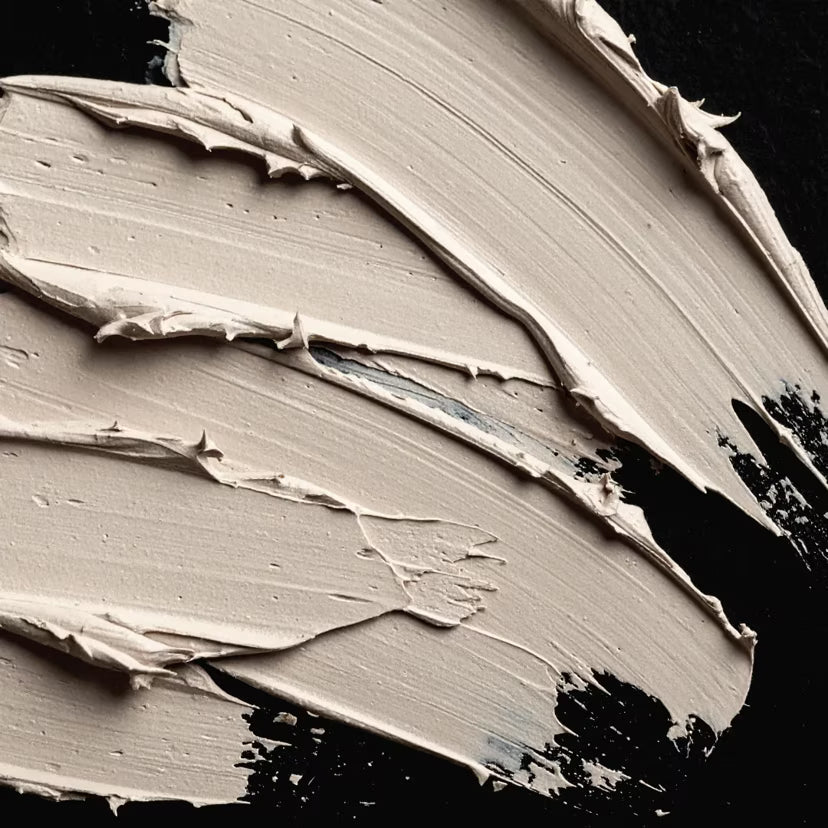 Close-up of beige paint texture on a black background