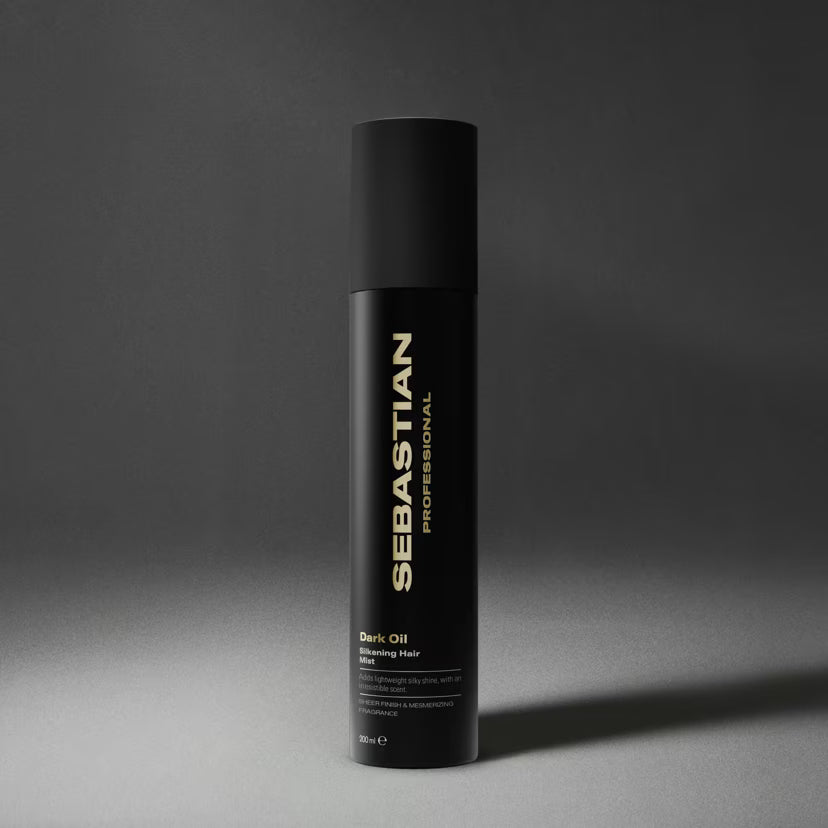 Sebastian Professional Dark Oil Bleaching Hair Spray in a matte black cylindrical bottle with gold lettering, set against a dark gray studio background.