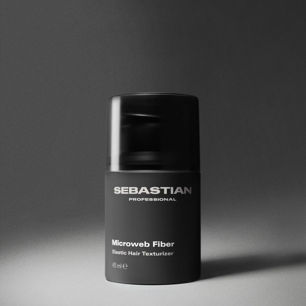 Black container of Sebastian Professional Microweb Fiber on a gray background