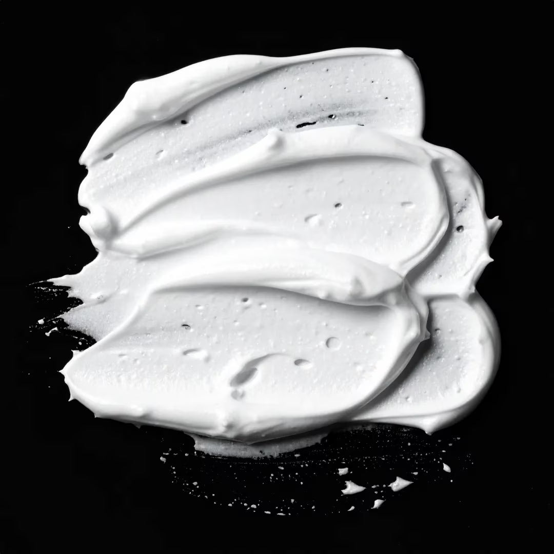 White cream or frosting on a black background