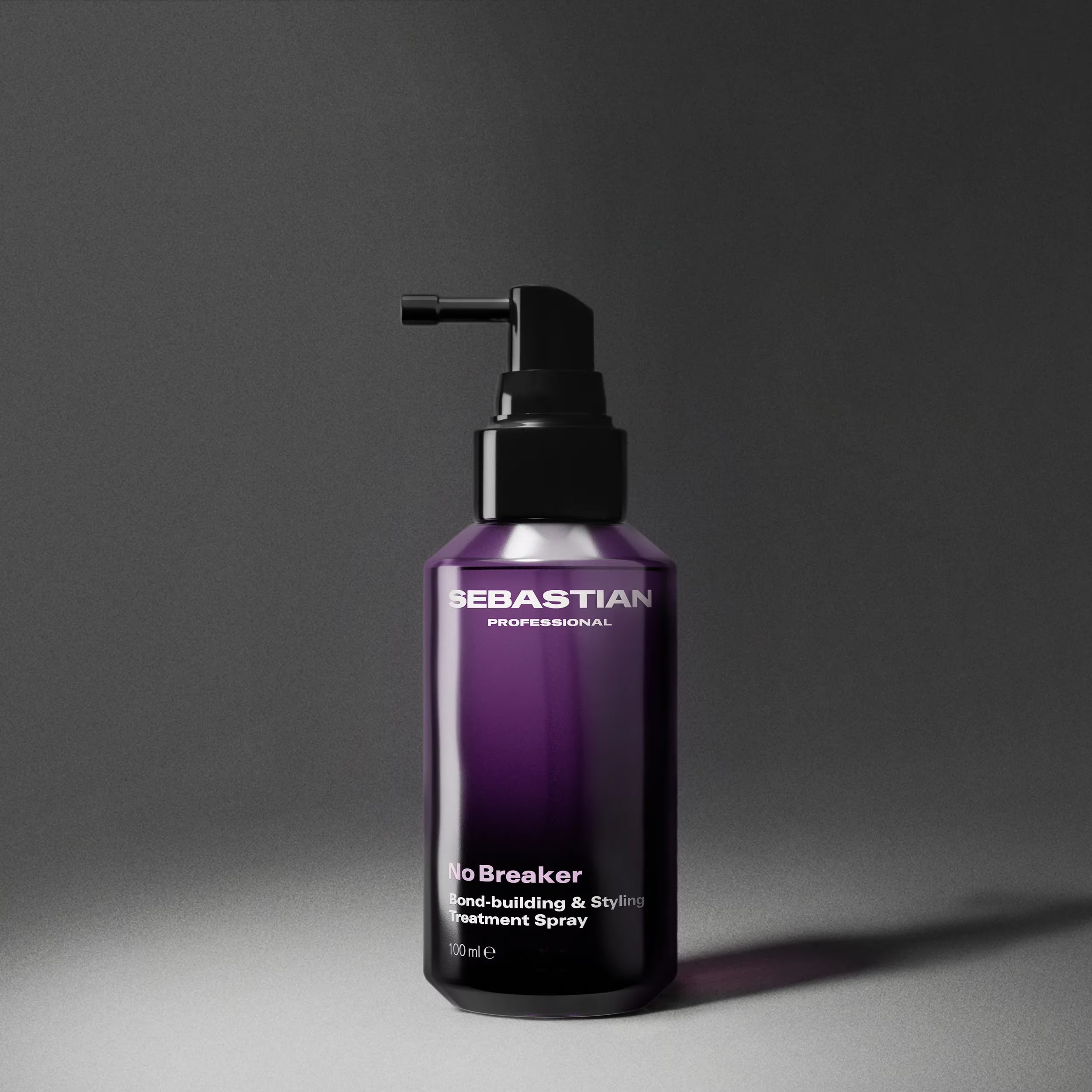 Purple bottle of Sebastian Professional hair product on a gray background