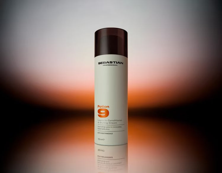 A bottle of Sebastian Professional Potion 9 Hair Building Fibroblast Serum, featuring a white bottle with a dark brown cap, set against a blurred warm-toned gradient background.