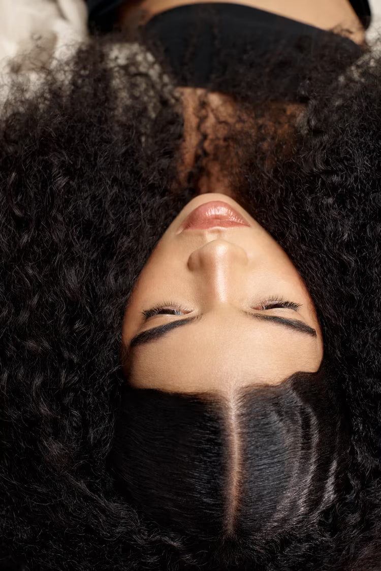 Person with textured hair looking upwards