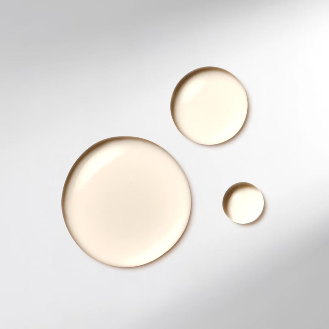 Three round, gold-colored objects on a light gray background