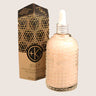 Cult and King's JELLY, a pink Himalayan salt infusion for hair, comes in a glass bottle with natural texture and a dropper. A box with geometric designs accompanies it, enhancing the presentation.