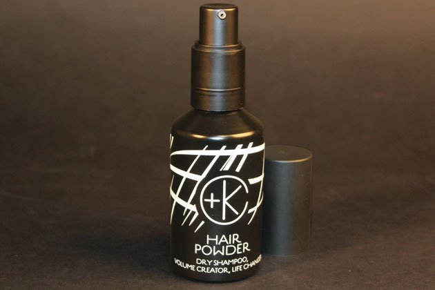 Against a dark background, a black spray bottle labeled "Cult and King PUMPABLE HAIR POWDER" is displayed. This talc-free dry shampoo is infused with antioxidant-rich powder and Kaolin clay, providing a refreshing boost for your hair.