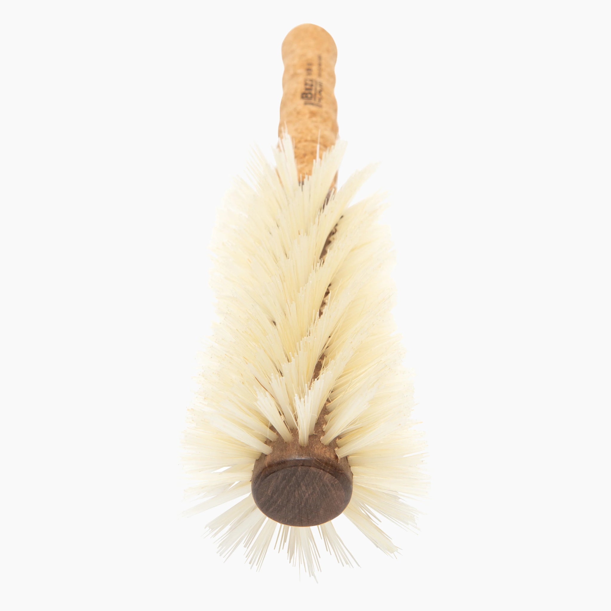 Dish brush with natural bristles and cork handle on a white background
