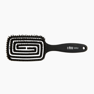 Black hairbrush with white bristle pattern on a white background
