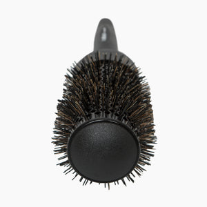 Black round hairbrush with bristle head on a white background