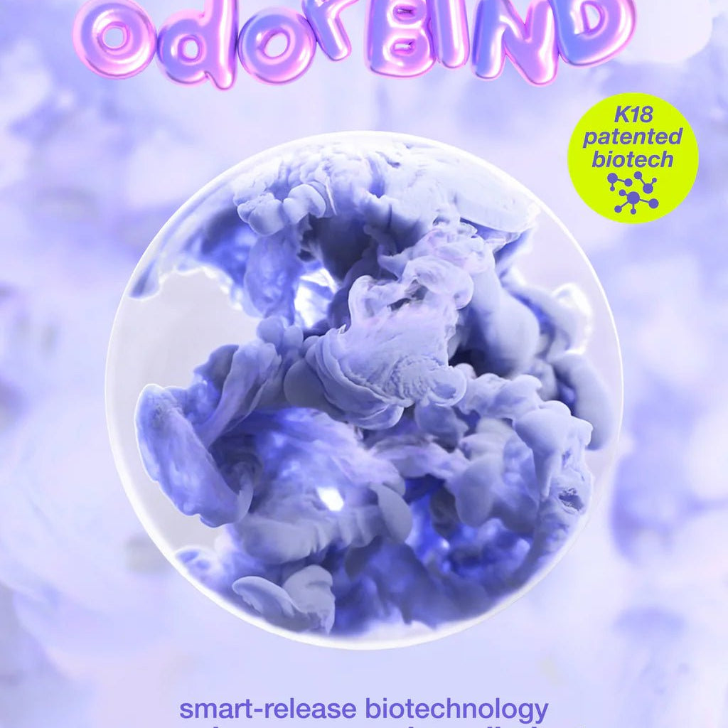 Promotional image for "K18 AirWash Dry Shampoo" by K18 Hair Repair, highlighting its use of K18 patented biotechnology to identify, neutralize, and remove odors while promoting scalp health. Effective for up to 3 days. Background features a purple abstract design.