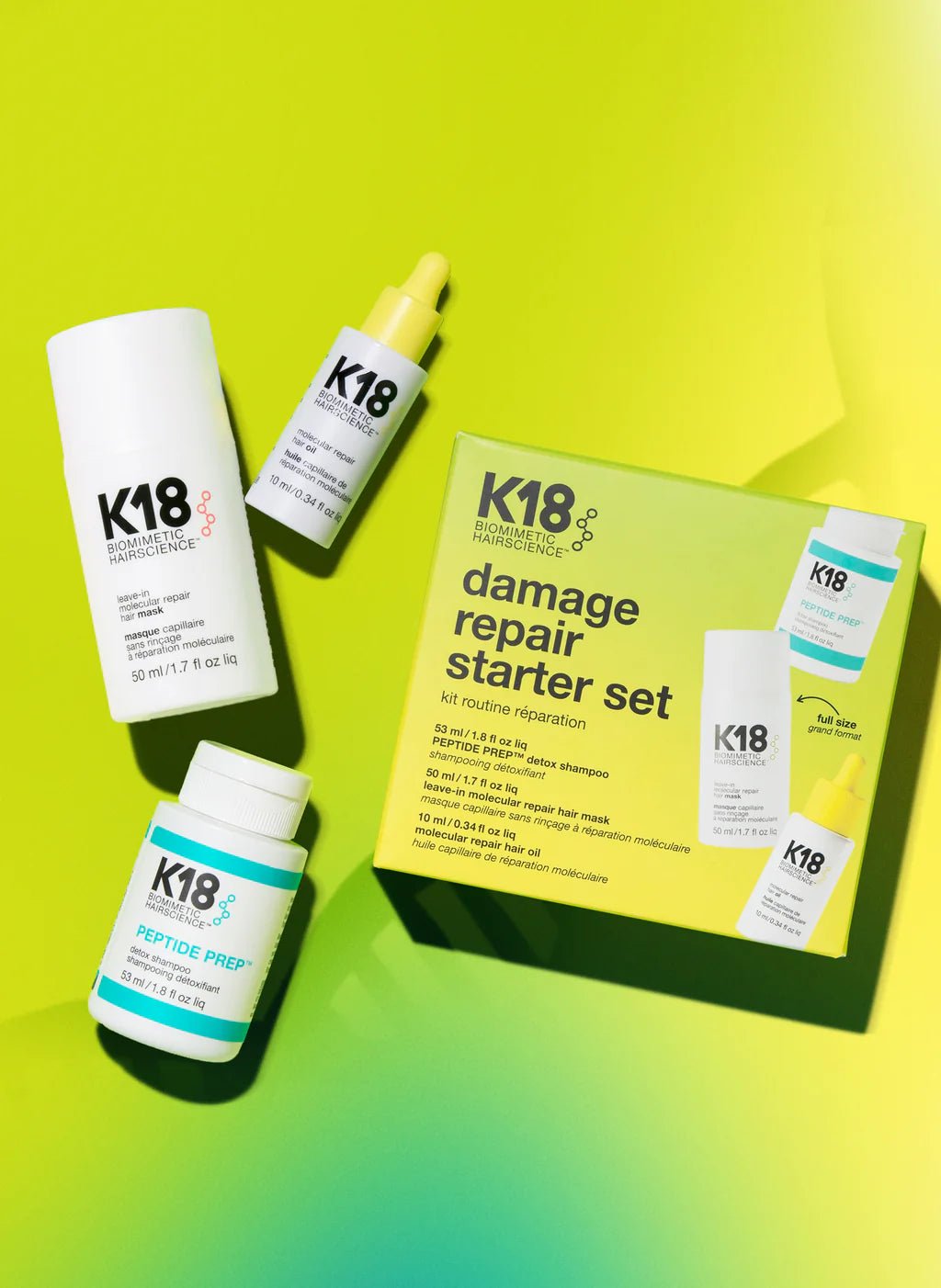 Image of K18 Hair Repair products against a gradient yellow-green background, featuring the K18 Damage Repair Starter Set, including a bottle of leave-in molecular repair hair mask, a bottle of peptide prep shampoo, and a bottle of hair oil. These vegan products harness the power of K18Peptide to reverse damage effectively.