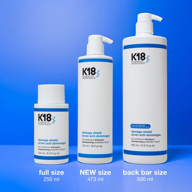 Three K18 hair care product bottles on a blue background