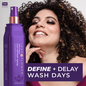A smiling woman with curly hair poses behind a purple bottle of Leaf and Flower Instant Curl Refresh Spray. Text on the image reads: “DEFINE + DELAY WASH DAYS.” The bottle is labeled THC FREE.