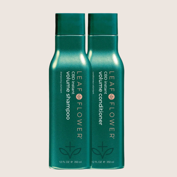 Two teal bottles of Leaf and Flower Instant Volume Shampoo and Conditioner Duo for fine hair, 12 fl oz each, feature white and gold text with a leaf design at the bottom.