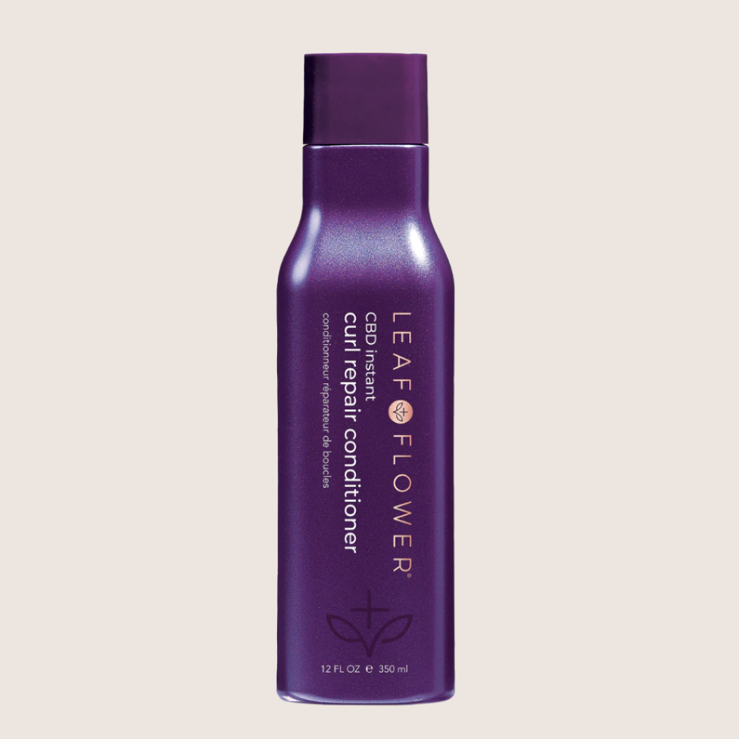 Purple bottle of Leaf and Flower Instant Curl Repair Conditioner, 12 fl oz (350 ml). Enjoy enhanced curl repair, moisture replenishment, and frizz reduction for smooth, bouncy locks.