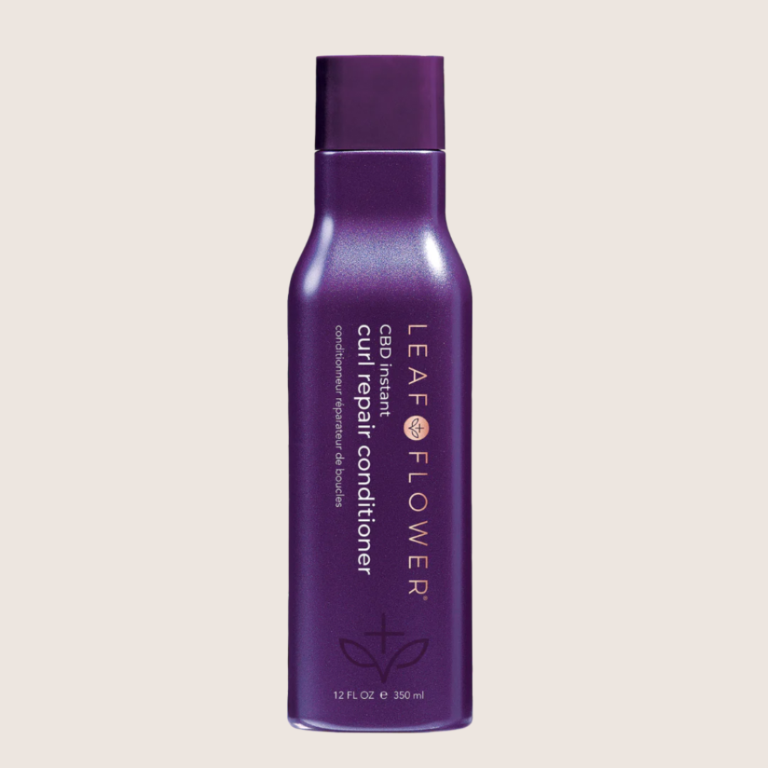 A purple bottle of Leaf and Flower Instant Curl Repair Conditioner for all curl types.