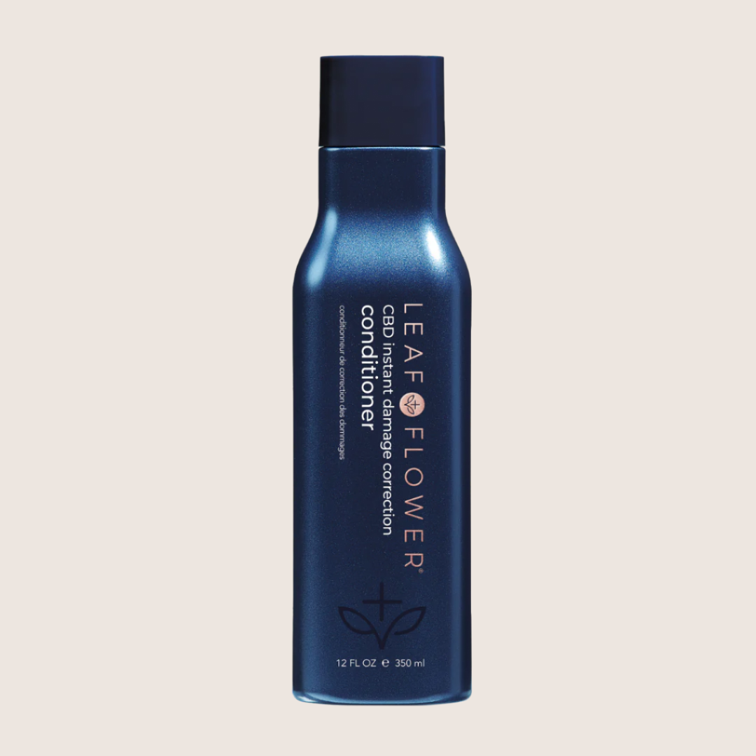 A bottle of hair conditioner for Leaf and Flower, the Leaf and Flower Damage Correction Conditioner.